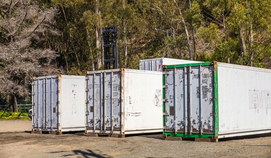 Shipping containers staged for transport — a 2.5MWh BESS ships as one pre-tested container